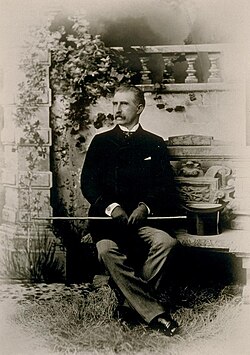John William Mackay in later life, seated in a garden, portrait photograph