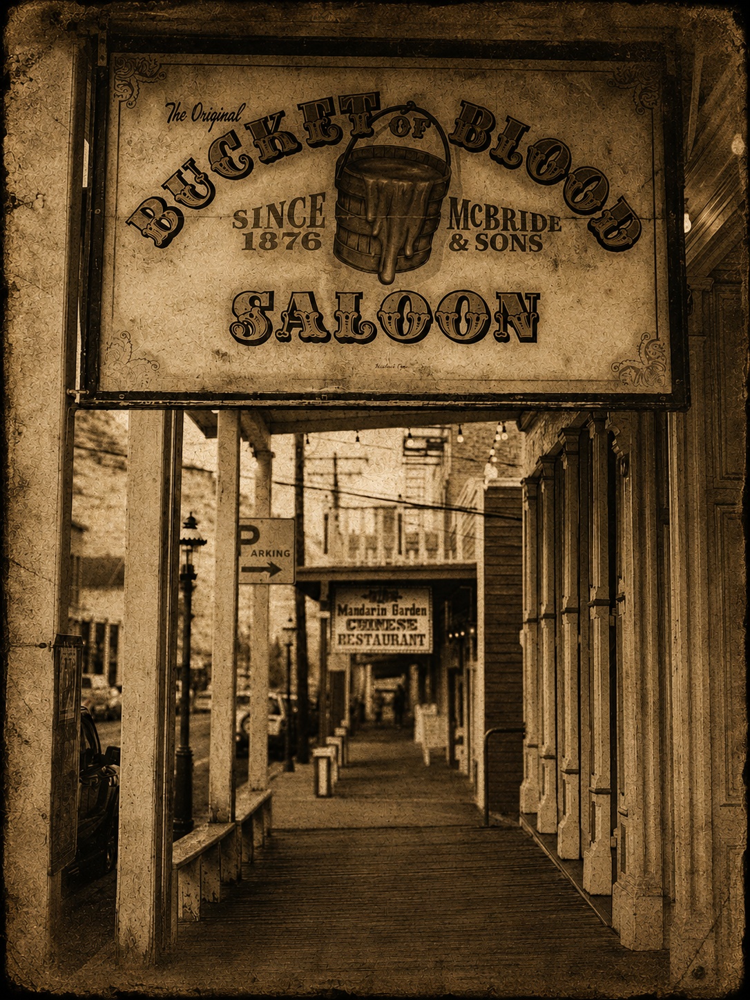 Antique-style sign for the Bucket of Blood Saloon in Virginia City, reading Since 1876, McBride and Sons, with the town's covered boardwalk visible below