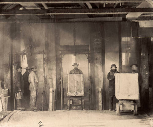 Miners and hoisting cars at the Curtis Shaft, Savage Mine, Virginia City, 1867 to 1868