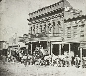 Nineteenth-century street scene in Virginia City, Nevada, with a horse-drawn stagecoach and false-front business buildings